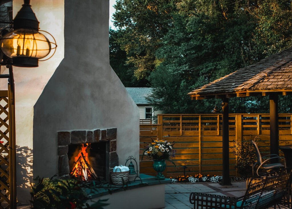 Outdoor fireplace installed next to stone paver sitting area